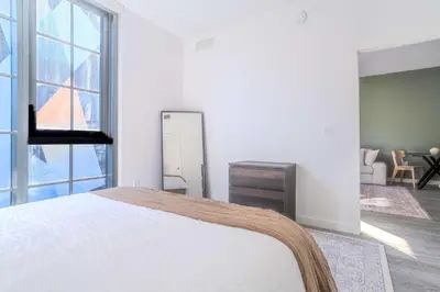 a white bedroom with a bed and a large window at The Juliet XIV Vibe 8801 in Miami