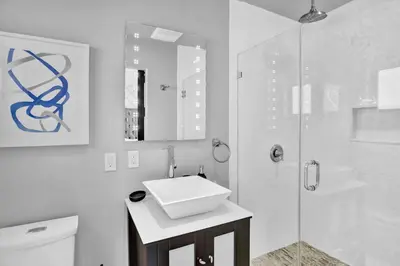 a white bathroom with a sink and a shower at Oasis 5 Bed, 3 Bath Pool Home Minutes to the Beach in Hollywood