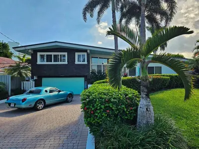 a blue car parked in front of a house at The Bird-2 blocks to beach-Heated Pool-Hot Tub in Fort Lauderdale