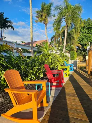 a row of colorful chairs sitting on a sidewalk at The Bird-2 blocks to beach-Heated Pool-Hot Tub in Fort Lauderdale