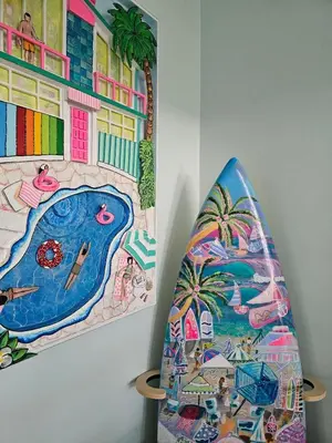 a surfboard next to a painting of a pool at The Bird-2 blocks to beach-Heated Pool-Hot Tub in Fort Lauderdale