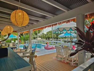 a pool with a pink flamingo in a swimming pool at The Bird-2 blocks to beach-Heated Pool-Hot Tub in Fort Lauderdale