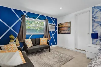 a living room with a couch and a window at Stylish 4 Bed 2 Bath Pool & Spa in Hollywood