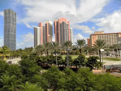 a city skyline with tall buildings and palm trees at Beautiful Sunny Isles apt 1br with PRIVATE TERRACE in Sunny Isles Beach