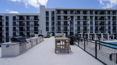 a balcony with a table and a grill on a building at High Floor Property-Expansive Views- Sleep 6 Miami in North Miami