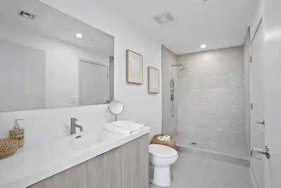 a bathroom with a toilet and a sink and a shower at Sleep 6 in Resort Style Community- Near Stadium in North Miami