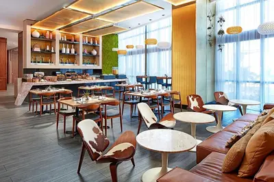 a restaurant with tables and chairs and a bar at The Grayson Hotel Miami Downtown in Miami