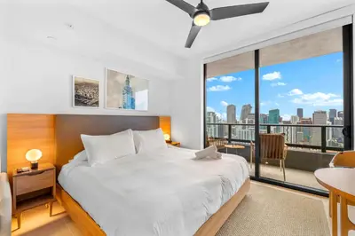 a bedroom with a large bed and a large window at Fly Hight - Studio W Free Parking in Miami