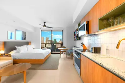 a bedroom with a bed and a kitchen with a counter at Fly Hight - Studio W Free Parking in Miami