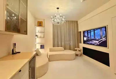 a large living room with a chandelier and a living room at Chic & Cozy 1BR in Miami Best South Beach Location in Miami Beach