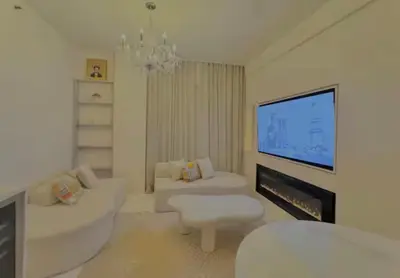 a white living room with a large screen tv at Chic & Cozy 1BR in Miami Best South Beach Location in Miami Beach