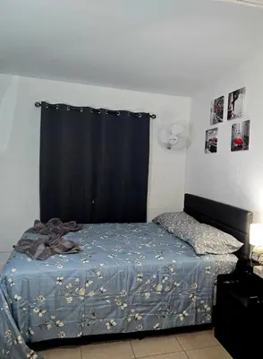 a bedroom with a bed with a black curtain at Miami Mini Escape 5 minutes from the airport in Miami
