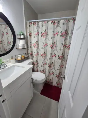 a bathroom with a toilet and a shower curtain at Miami Mini Escape 5 minutes from the airport in Miami