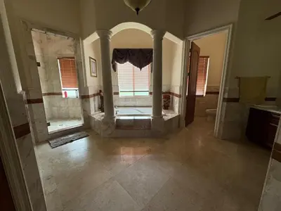 a large bathroom with a shower and a large window at Miami Mansion for Groups Sleeps 12 in Kendale Lakes