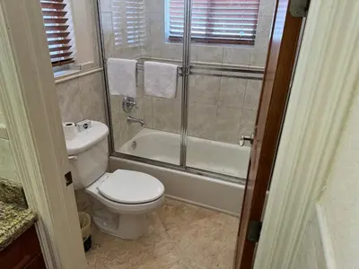 a bathroom with a toilet and a shower and a sink at Miami Mansion for Groups Sleeps 12 in Kendale Lakes