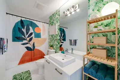 a bathroom with a sink and a toilet at Vibrant Downtown Haven with Rooftop Pool & Parking in Miami