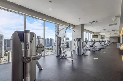 a gym with a view of a city skyline at Vibrant Downtown Haven with Rooftop Pool & Parking in Miami