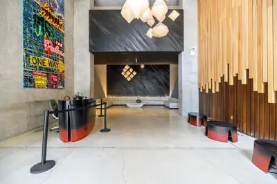a lobby with a table and a large wall at Vibrant Downtown Haven with Rooftop Pool & Parking in Miami