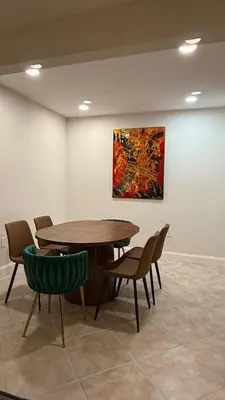 a table and chairs in a room with a painting at Close to the beach, in a quiet neighborhood in Hollywood