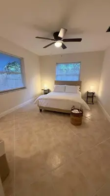 a bedroom with a bed and a ceiling fan at Close to the beach, in a quiet neighborhood in Hollywood
