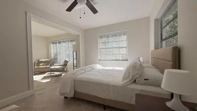 a bedroom with a bed and a ceiling fan at Close to the beach, in a quiet neighborhood in Hollywood
