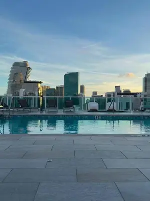 a swimming pool with a city skyline in the background at Modern Luxury Studio for Two in Downtown in Miami