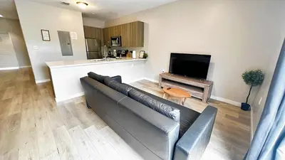 a living room with a couch and a flat screen tv at Free Parking 15 Min to Hard Rock Stadium in Miami