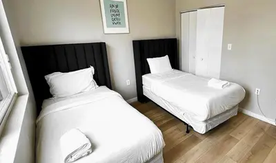 a small room with two beds in it at Free Parking 15 Min to Hard Rock Stadium in Miami