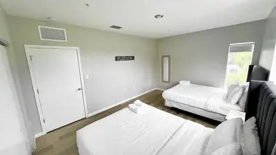 a bedroom with two beds and a sliding door at Free Parking 15 Min to Hard Rock Stadium in Miami