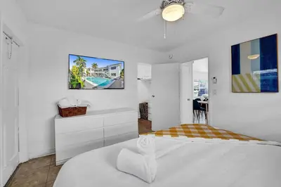 a white bedroom with a bed and a ceiling fan at Desoto 2 bedrooms first floor in Hollywood