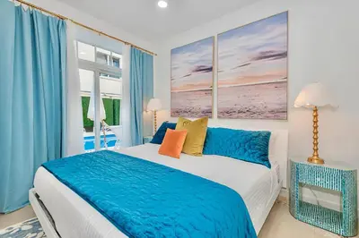 a bedroom with a large bed and a window at Boardwalk Steps from the Beach in Miami Beach
