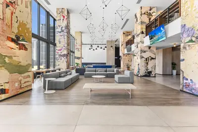 a lobby with couches and tables in a building at Prime Downtown Stay 2BR- Parking Included -Near Bayside & Cruise Port in Miami