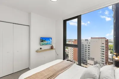 a bedroom with a bed and a large window at Prime Downtown Stay 2BR- Parking Included -Near Bayside & Cruise Port in Miami