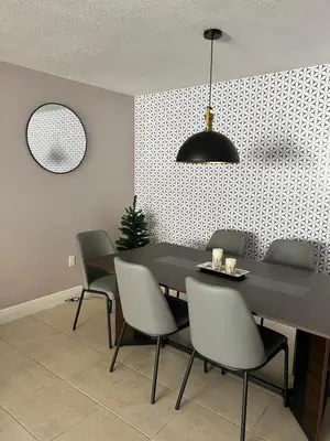 a dining room with a black table and chairs at Vacation QJR in Cutler Bay