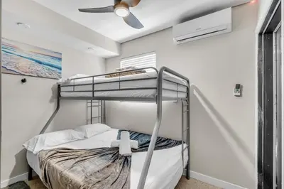 a bunk bed in a room with a ceiling fan at Compact Miami Suite in Miami
