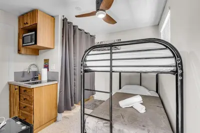 a small bedroom with a bunk bed and a sink at Compact Havana Suites - With Self Check-in in Miami
