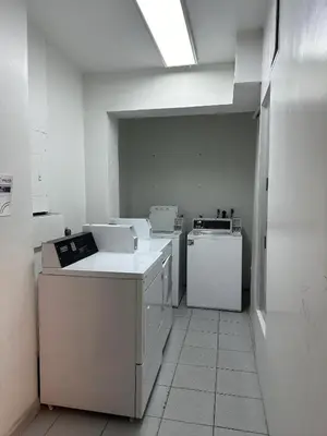 a kitchen with white appliances in a room at Casablanca Beachfront with full kitchen in Miami Beach