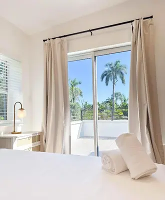 a bedroom with a bed and a large window at Family Pool Retreat 3 BR House for more than 8 Guests in Hollywood