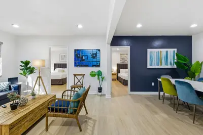 a living room with a blue accent wall at Prime Location Miami House W Free Parking in Miami