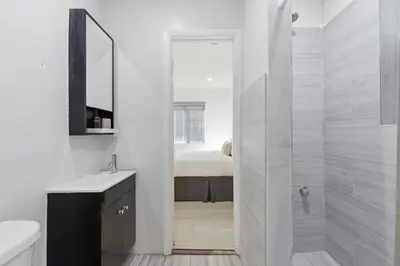 a white bathroom with a shower and a sink at Prime Location Miami House W Free Parking in Miami