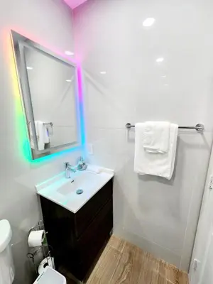 a bathroom with a sink and a mirror at Private & Quiet Retreat Near Hard Rock Stadium and Guitar Hotel in Pembroke Pines
