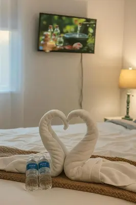 two swans making a heart on a bed at NEW House, Near Beaches, and MIA, Sleeps 8! in Westview