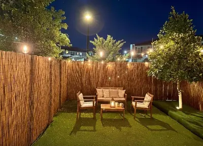 a backyard with a table and chairs and a fence at NEW House, Near Beaches, and MIA, Sleeps 8! in Westview