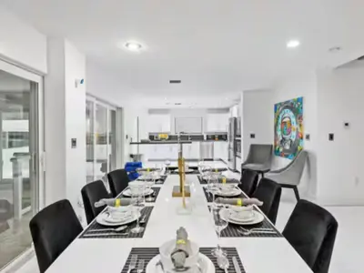 a large dining room with a long table and chairs at Villa Zenora in Miami