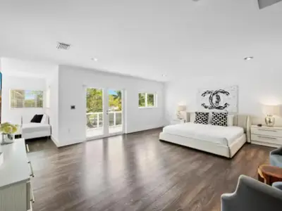 a living room with a white couch and a table at Villa Zenora in Miami