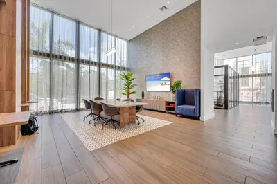 a large living room with a table and a tv at Brickell Border 3BR by Untitled Stay in Miami