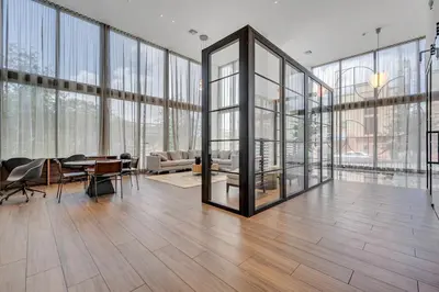 a large room with glass walls and a table at Brickell Border 3BR by Untitled Stay in Miami