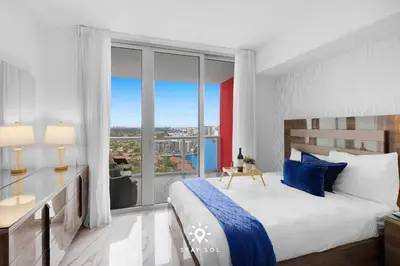 a bedroom with a large bed and a large window at Spacious 2BR apt - Amazing Balcony View in Hallandale Beach