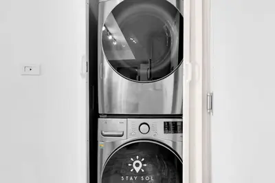 a microwave and a washing machine in a doorway at One Bedroom - Amazing Balcony in Hallandale Beach