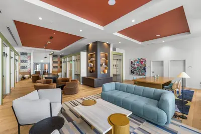 a living room with a blue couch and chairs at Skyline Views - Steps from Bayfront Park in Miami